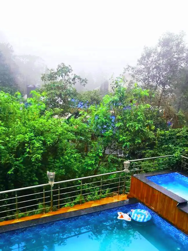 Swimming pool with waterfall and children's pool at the Lonavala villa